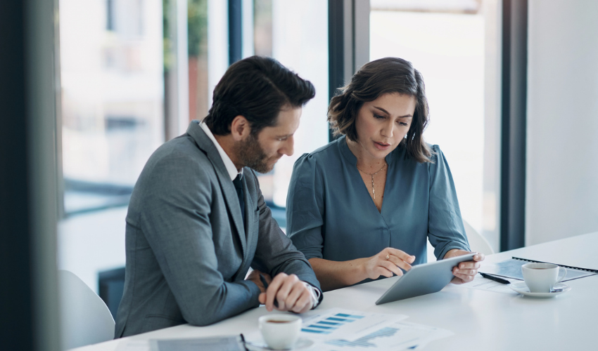 Two business people analysing data
