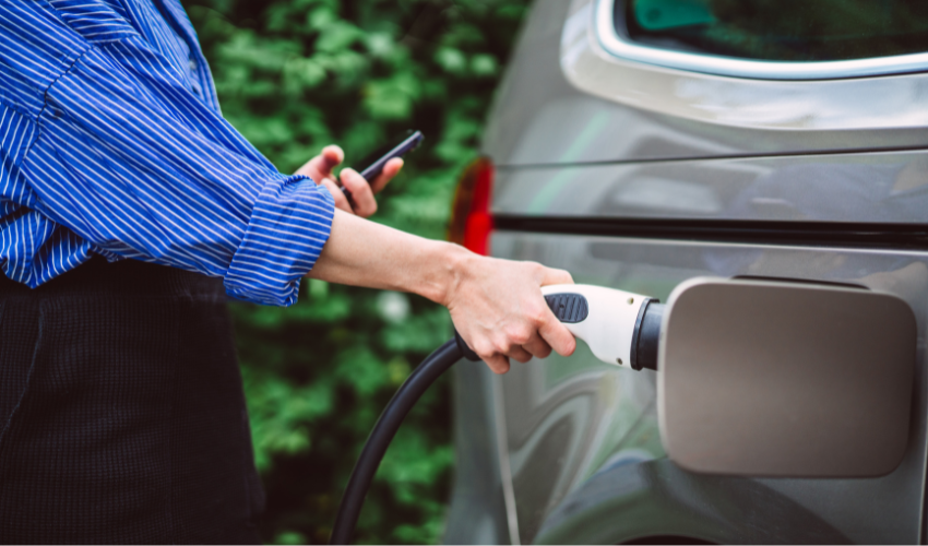 Woman charging an electric car