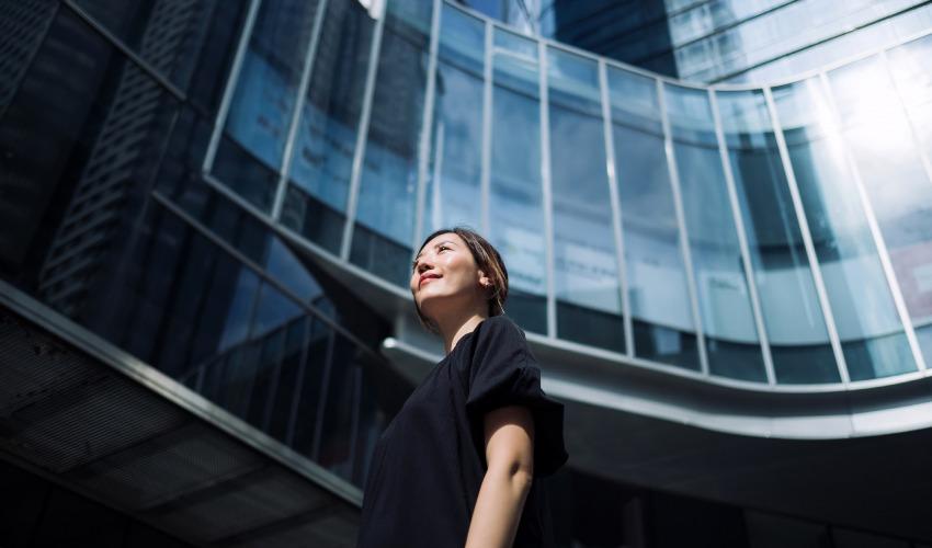 Women looking up to city landscape