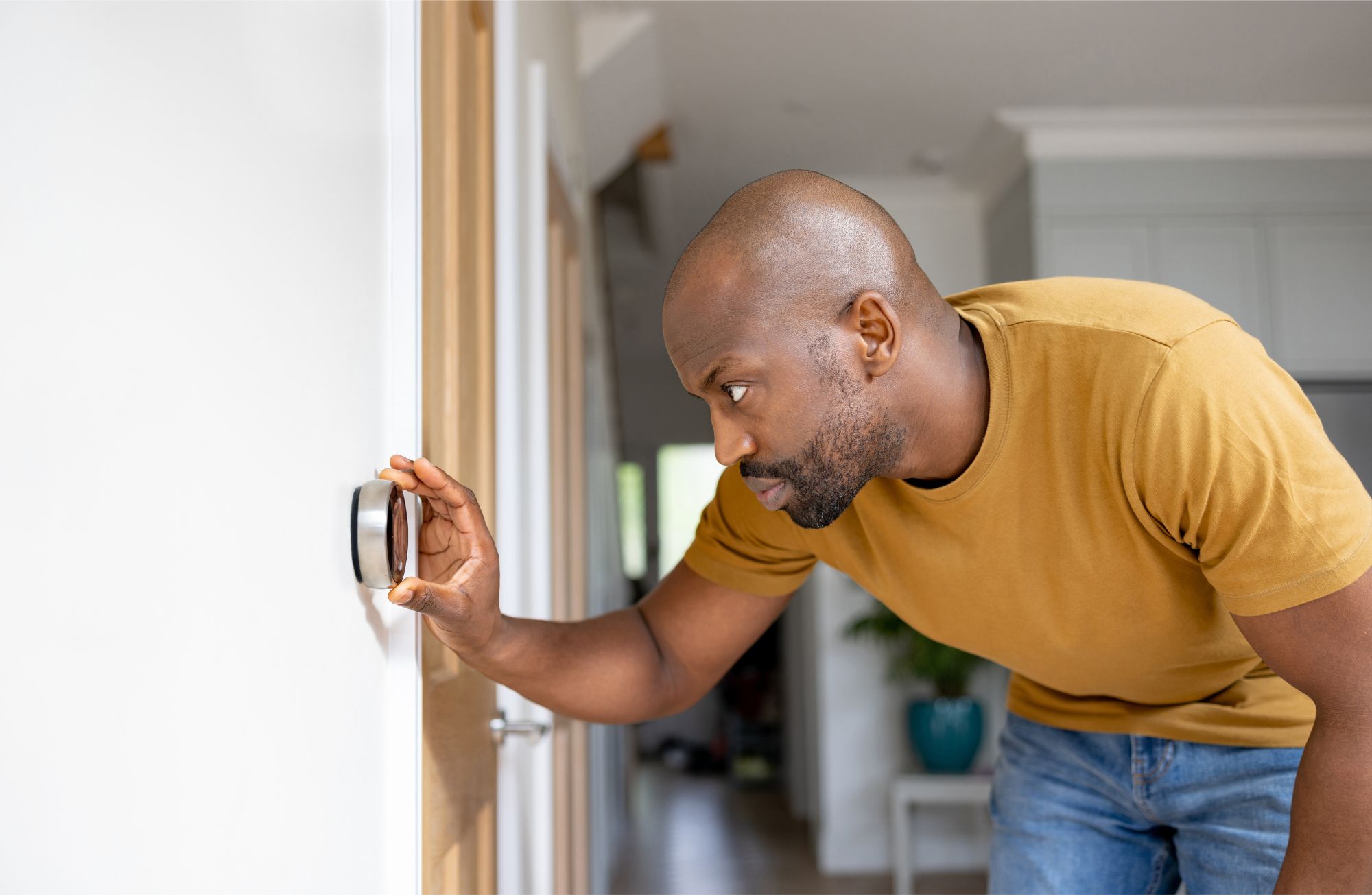 Man adjusting a thermostat