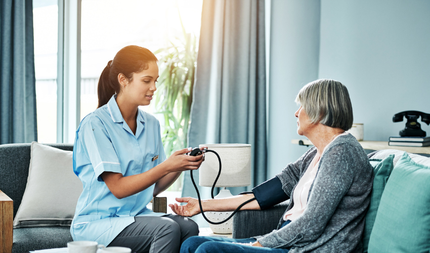 Home nurse checking a patient's blood pressure