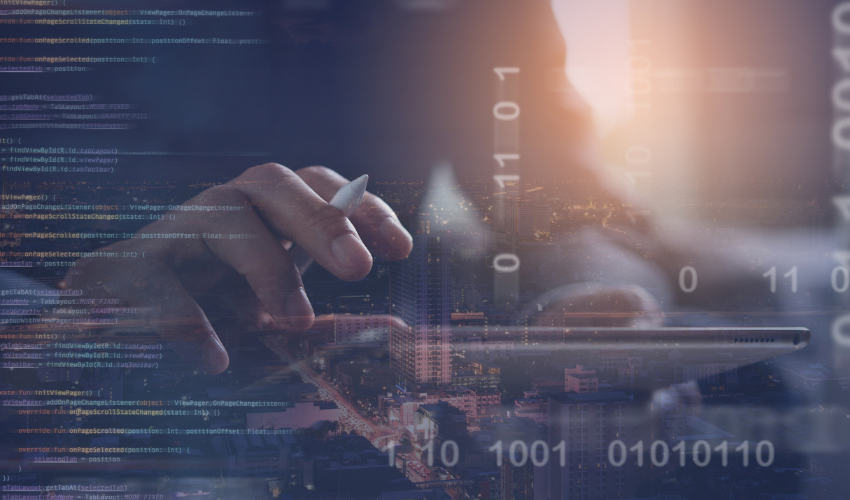 Hand holding a pen over a tablet