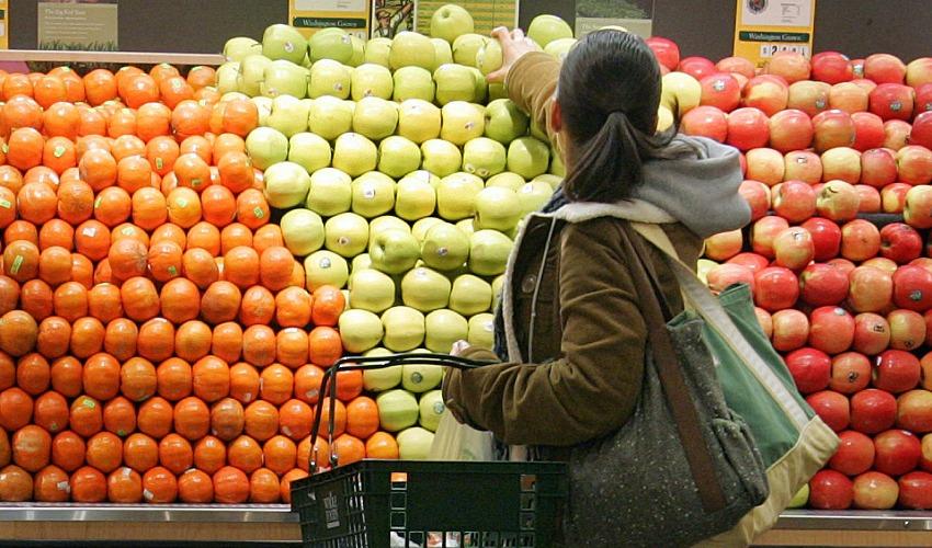 Women selecting a piece of fruit