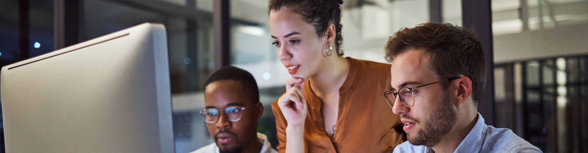 People in an office looking at a screen