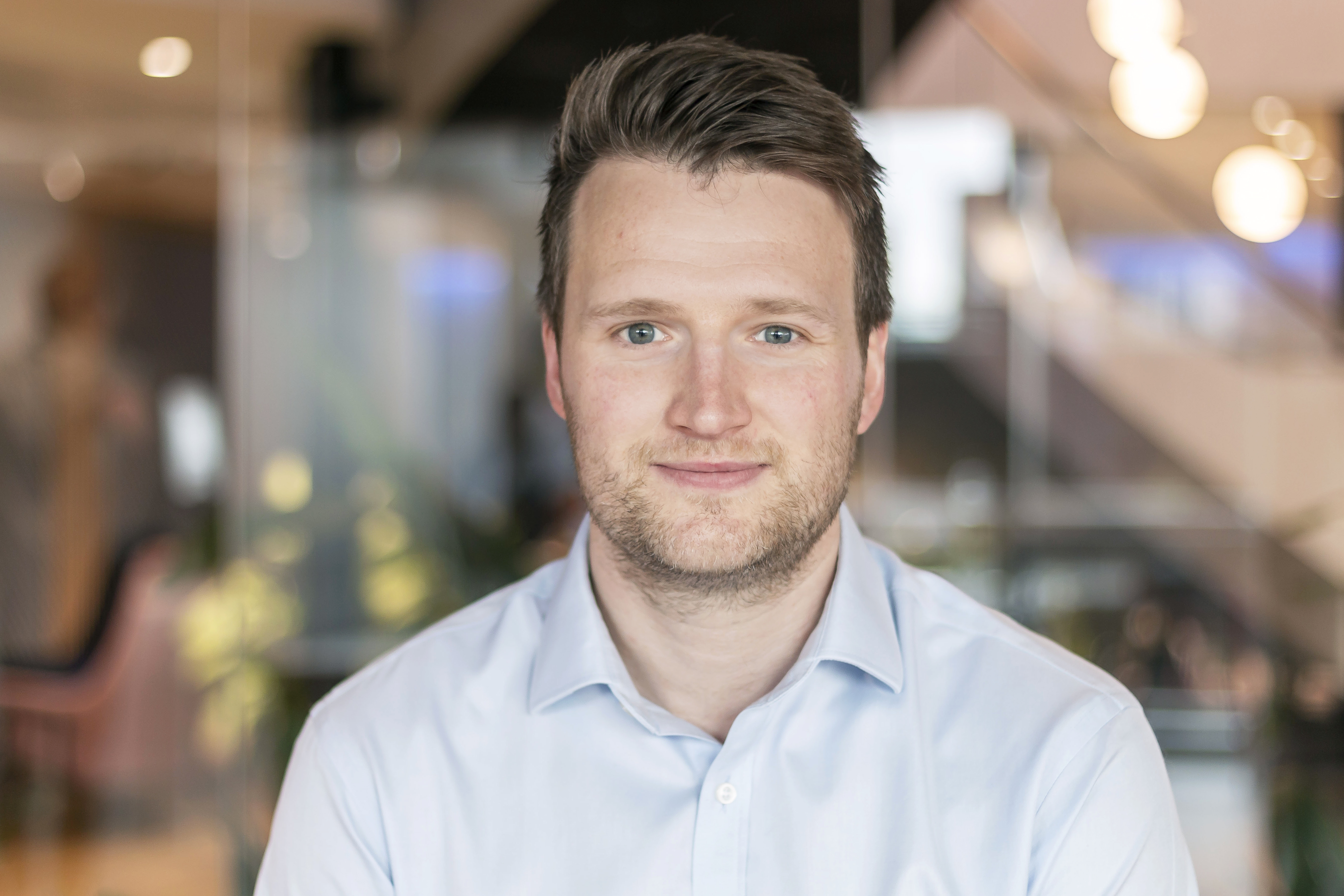 A professional headshot of Josh Elliot