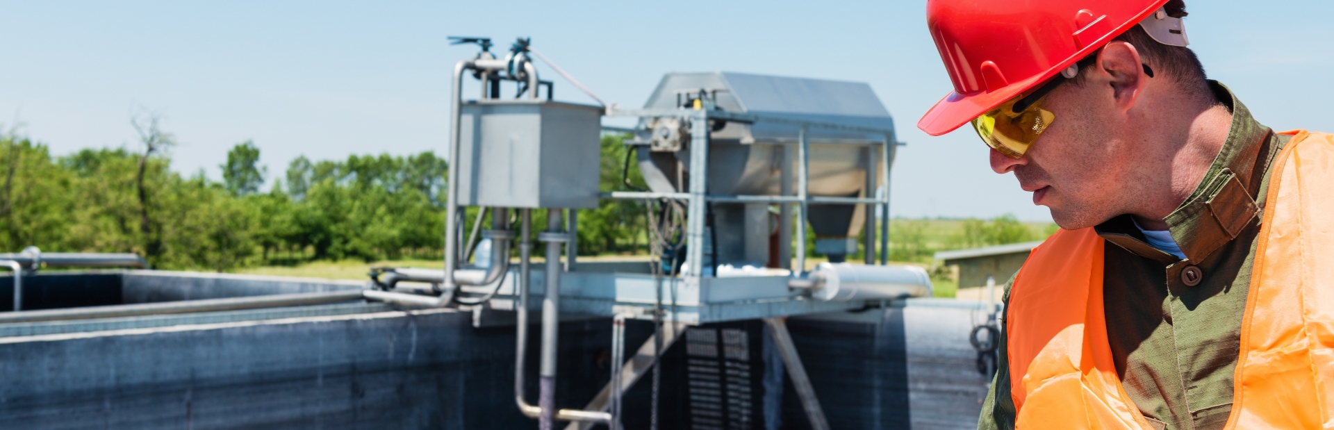A photograph of an Engineer looking at a water treatment site