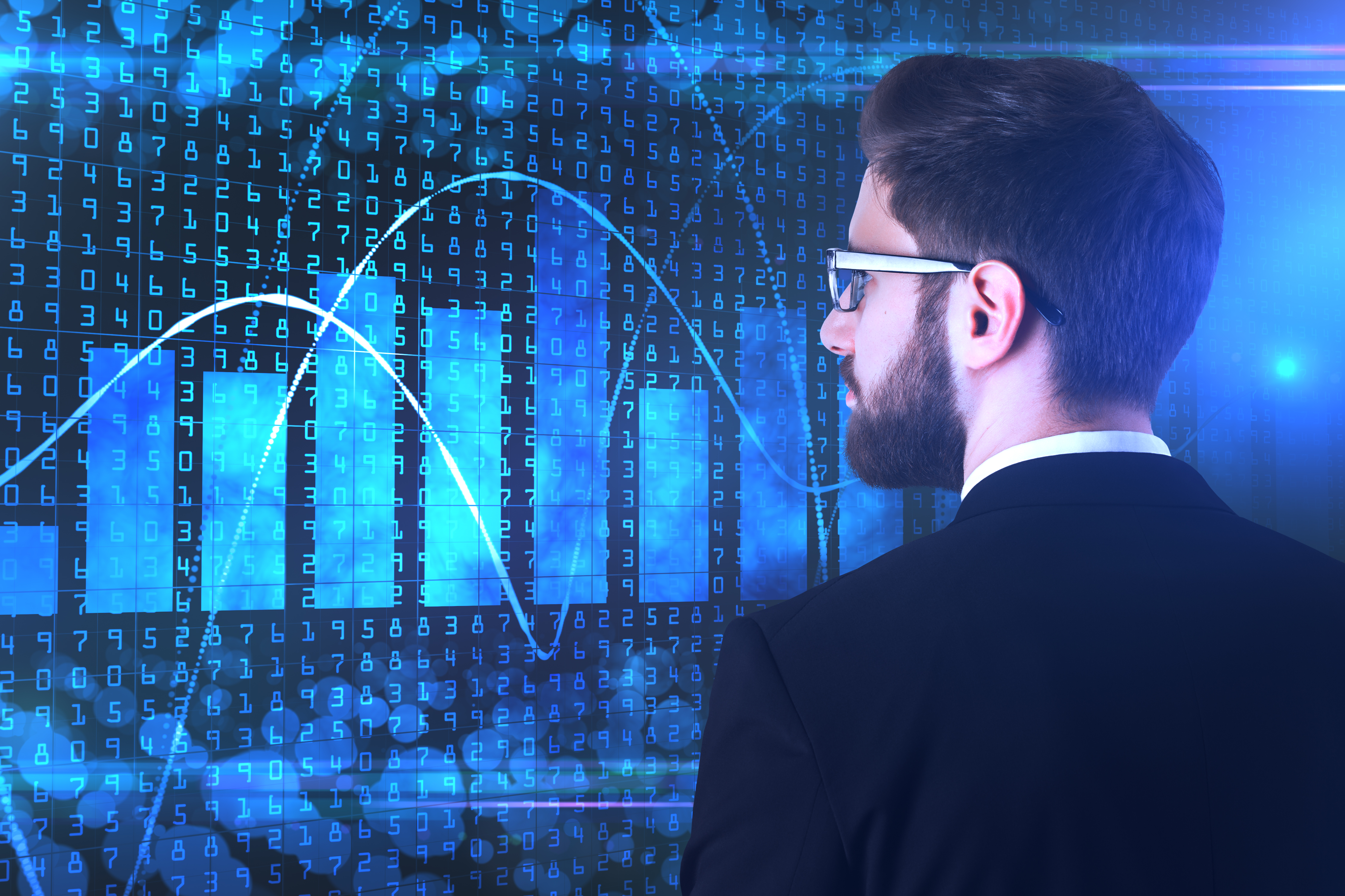 Man looking at charts on a screen