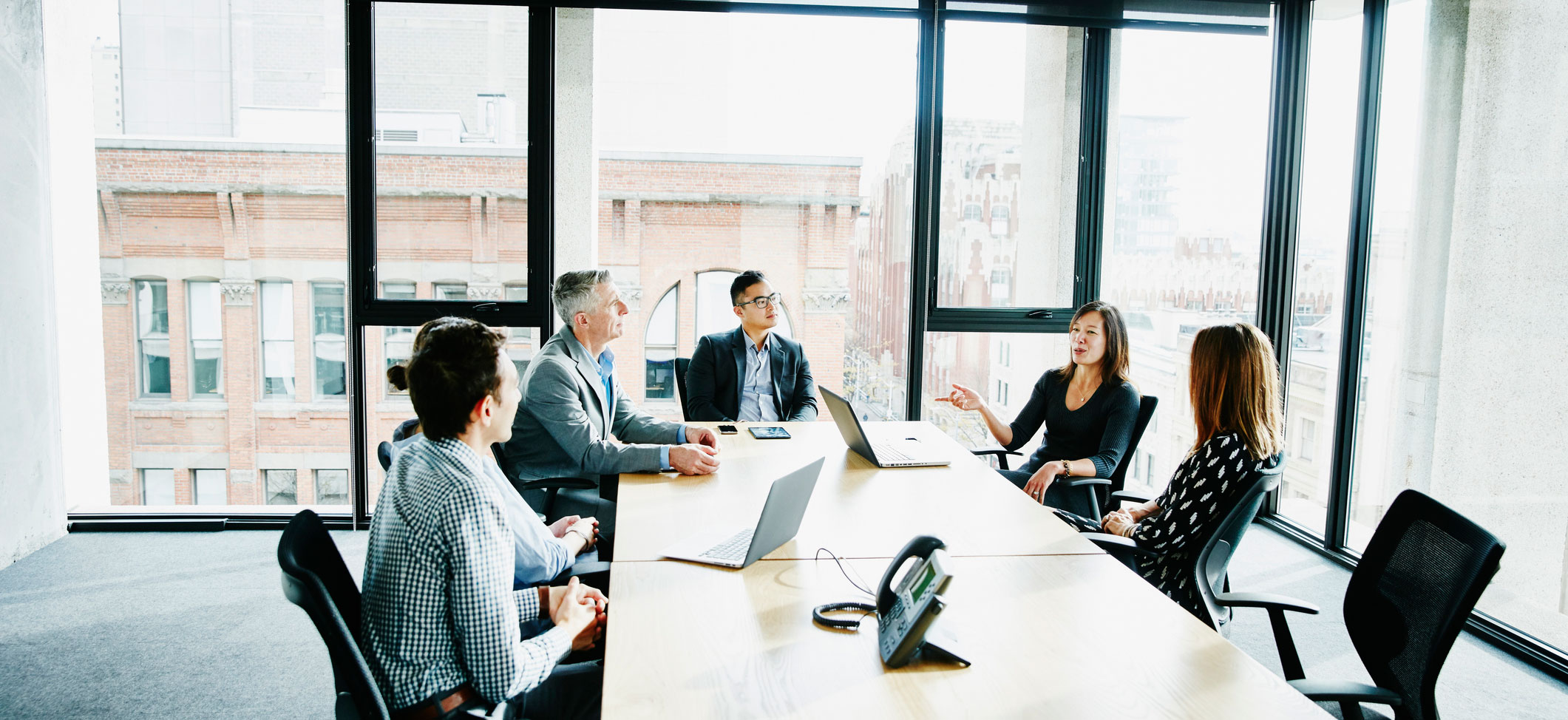 Five professionals having a meeting in an office