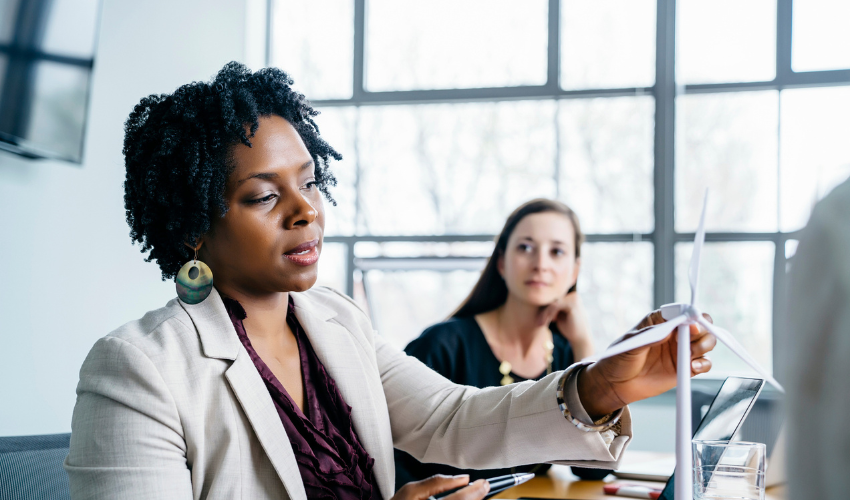 Woman demonstrating a wind turbine model