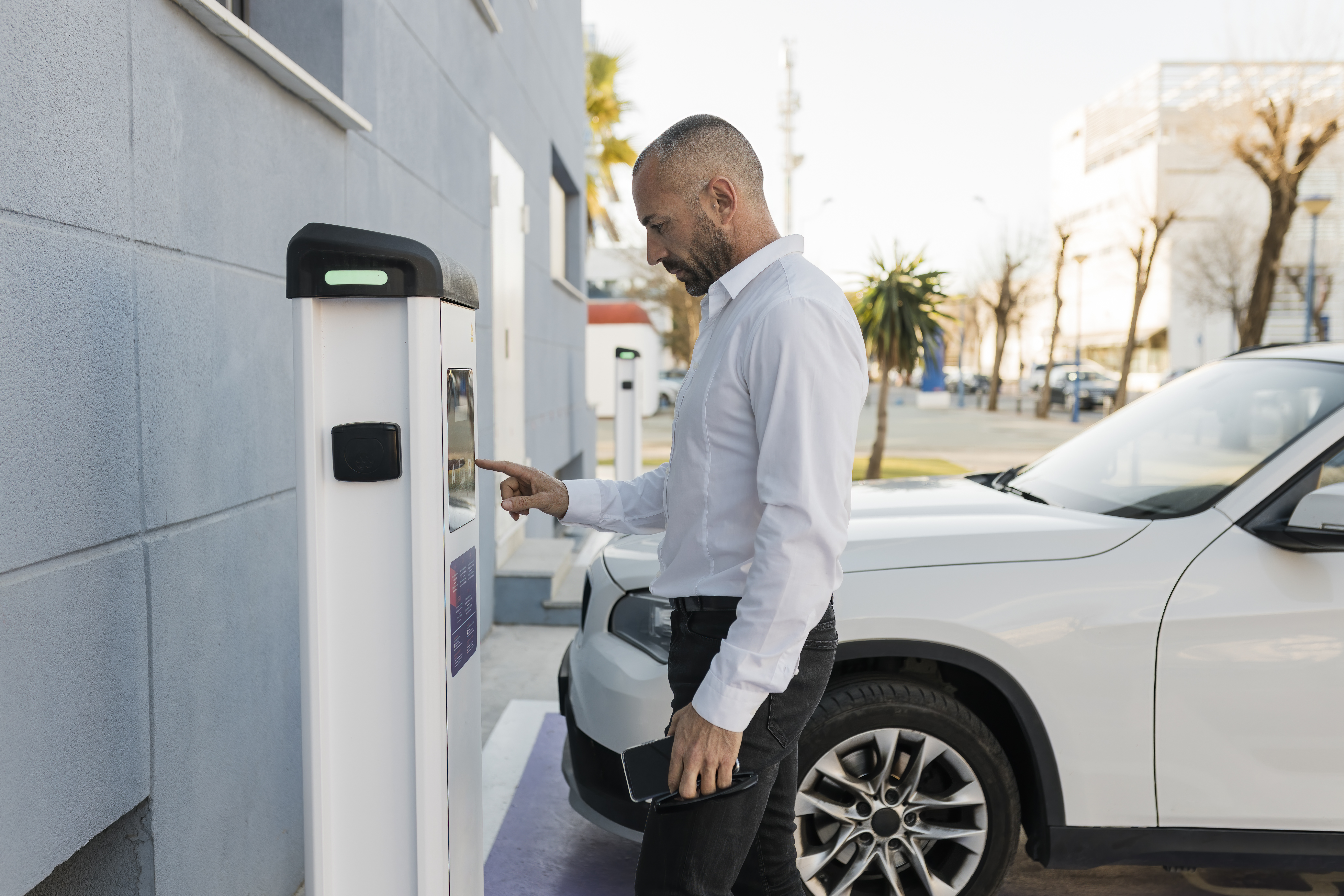 Man using an EV charger