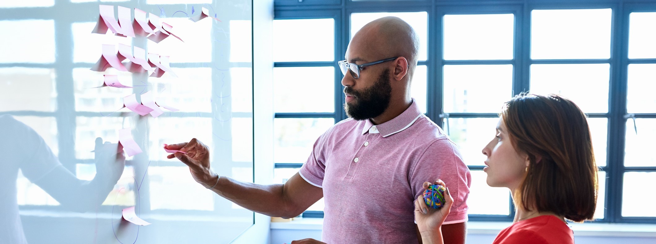 Two colleagues working on a board