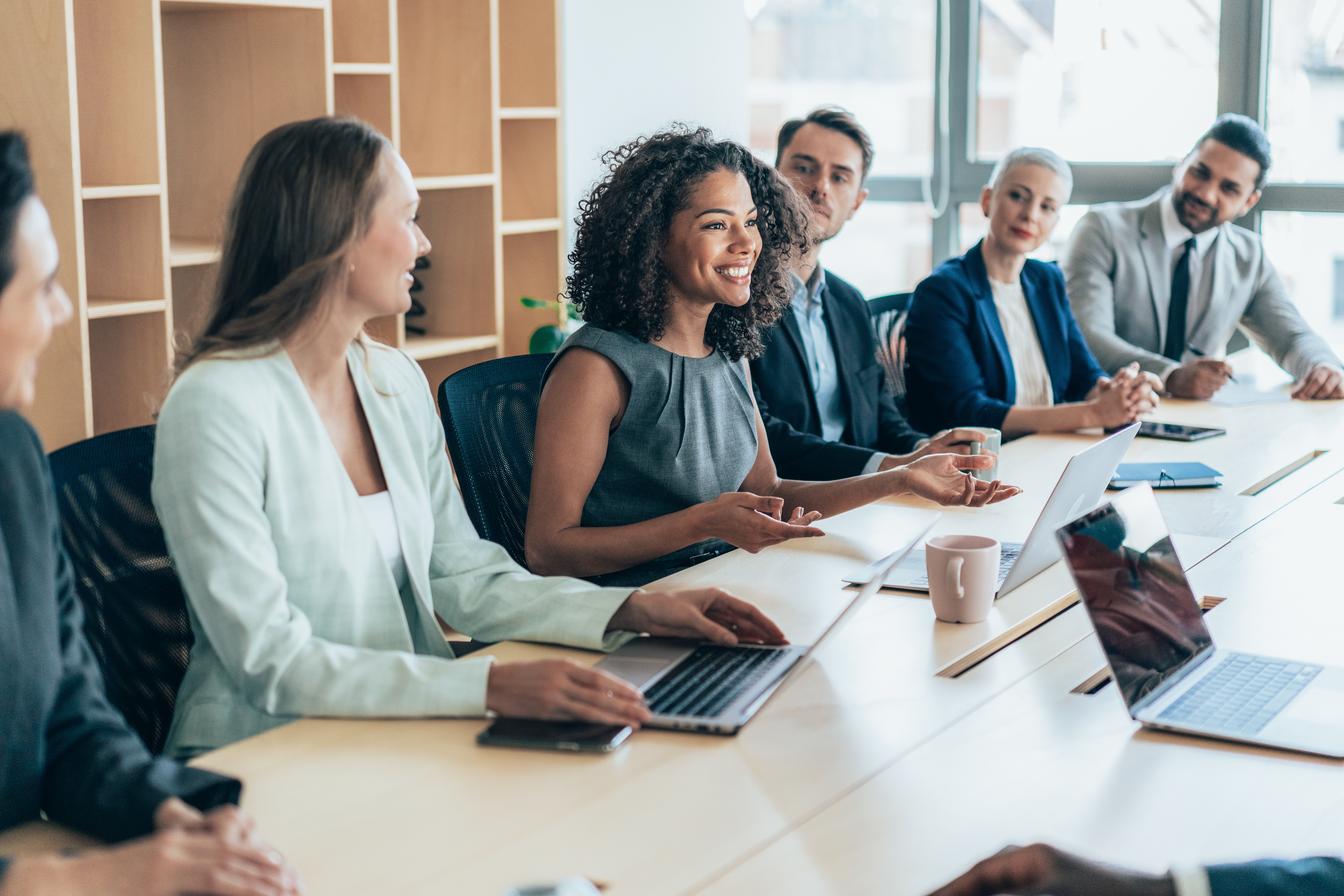 A woman smiling in a meeting 