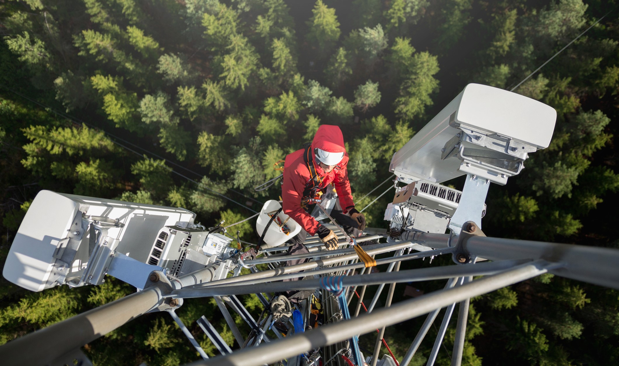 Worker climbing a communications tower