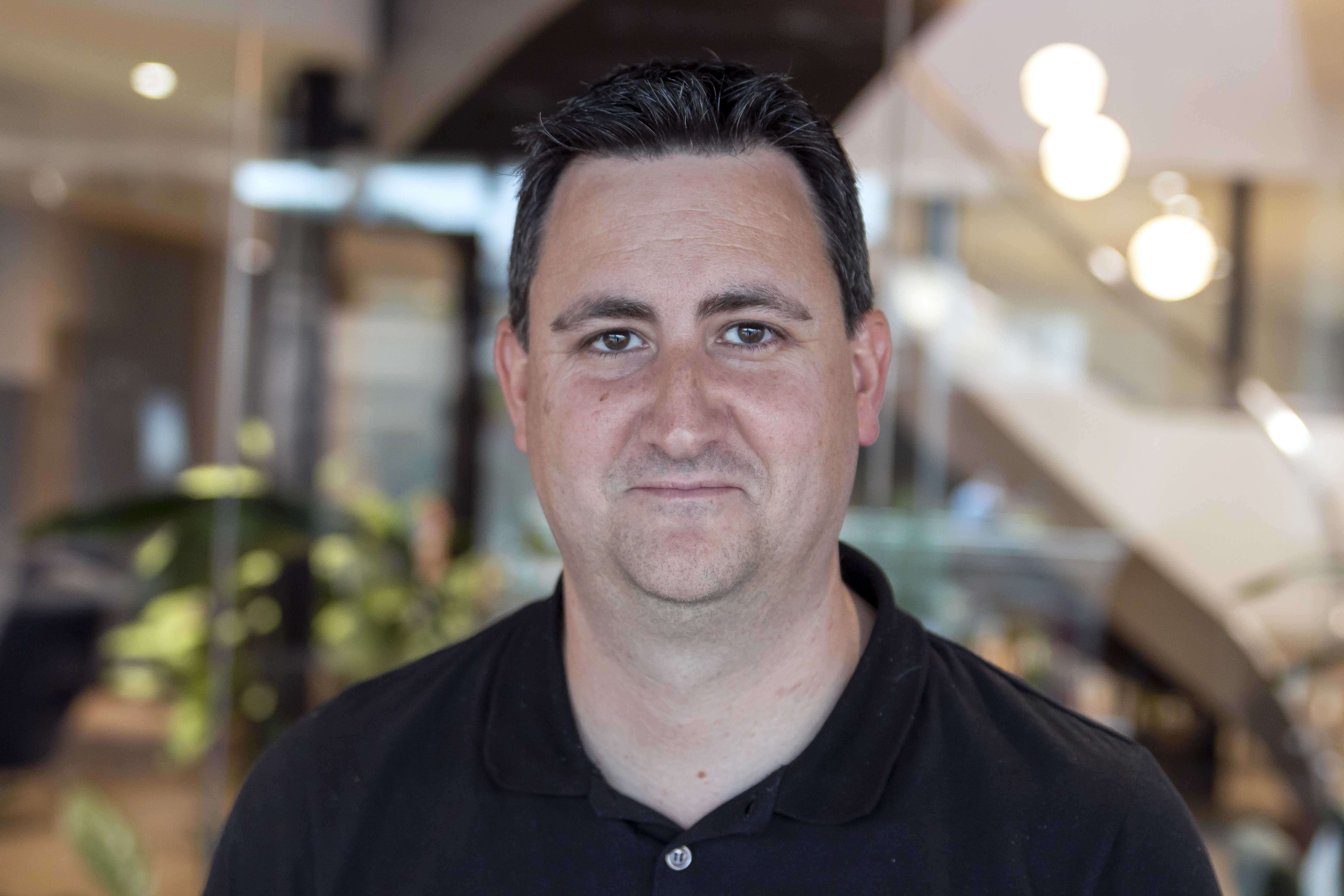 A professional headshot of Liam Collins