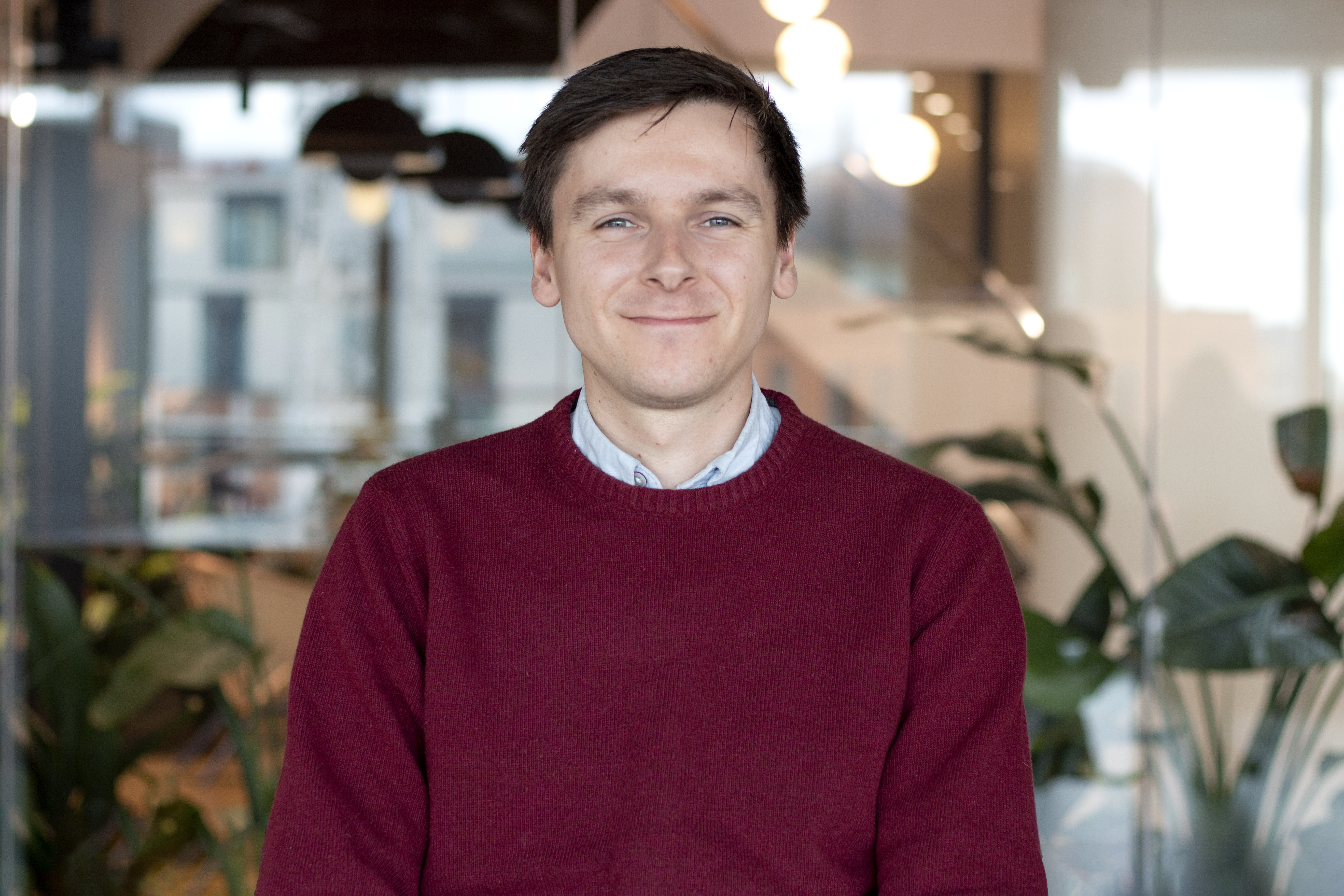 A professional headshot of Henry Holms