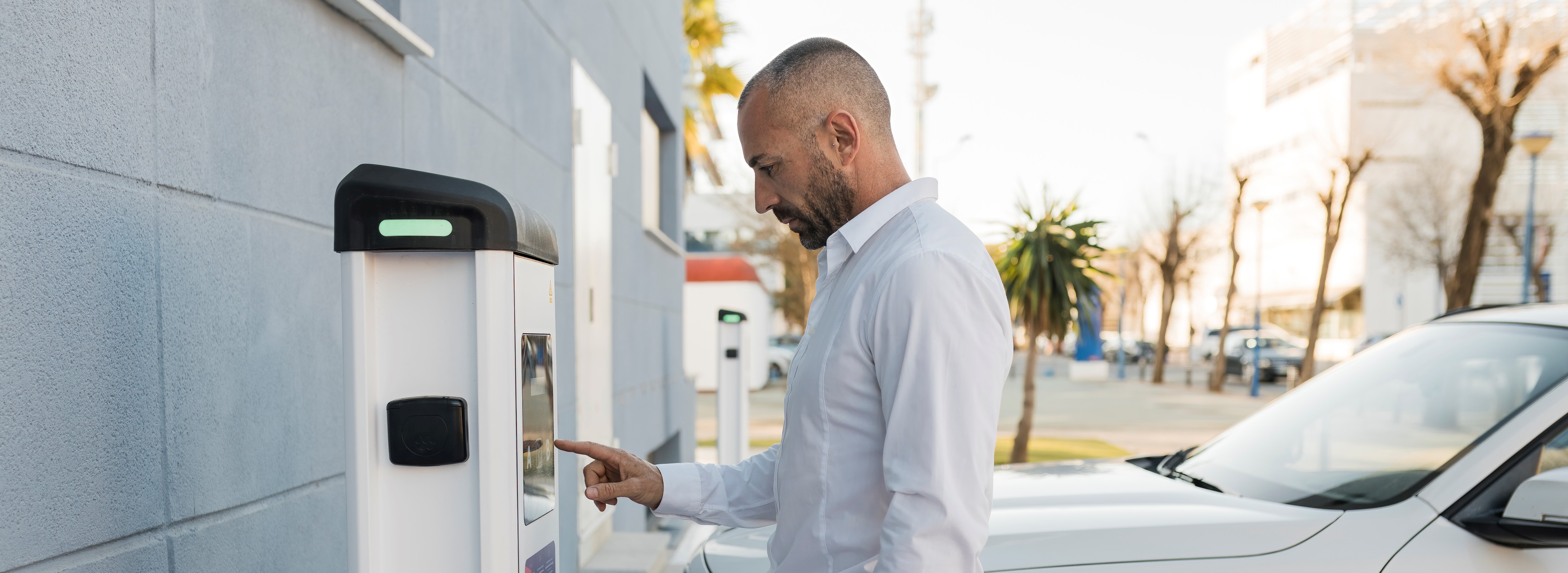 Man using an EV charger