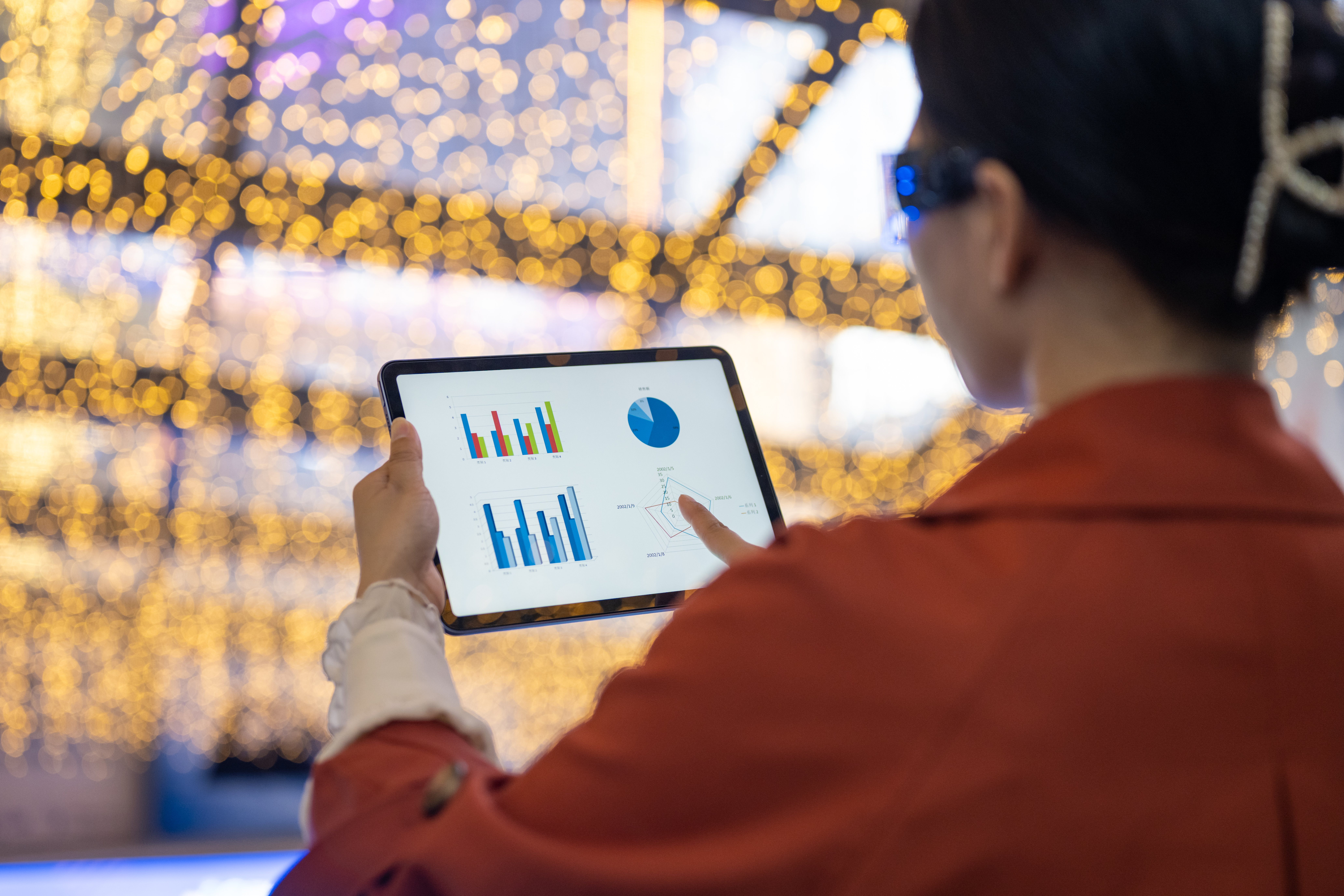 A person looking at data on a tablet