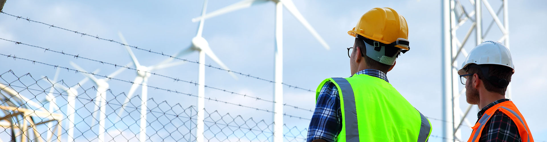 Workers looking at wind turbines
