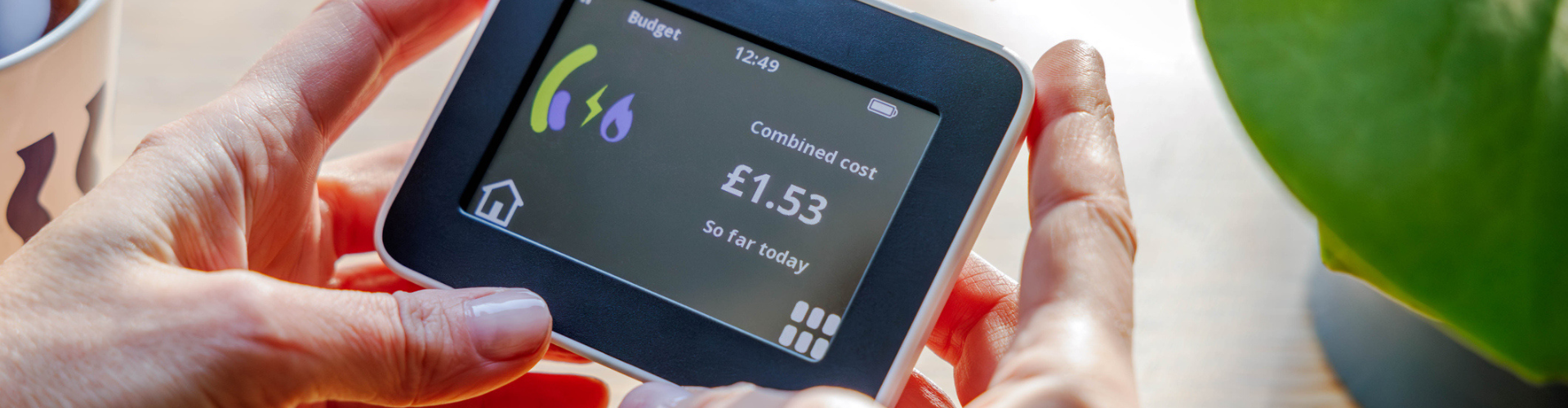 Hands holding a smart meter monitor