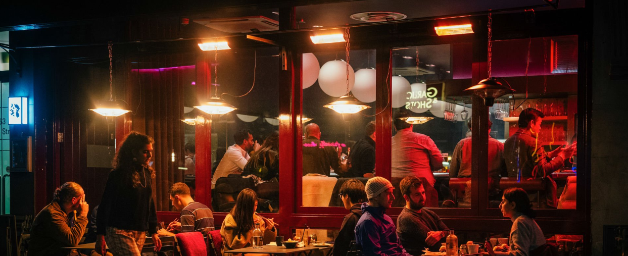People sitting in a bar restaurant at night