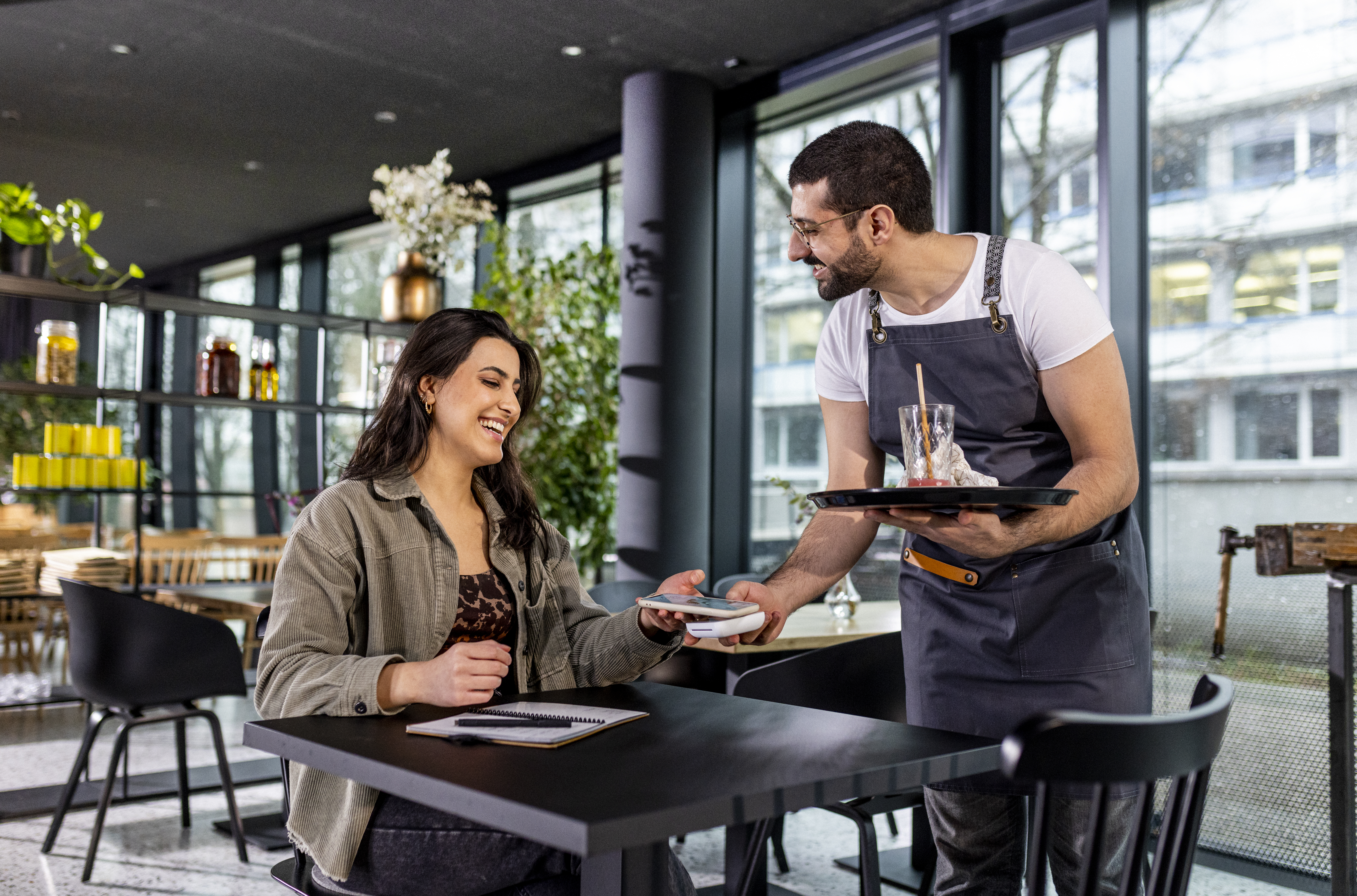 Woman paying in a cafe