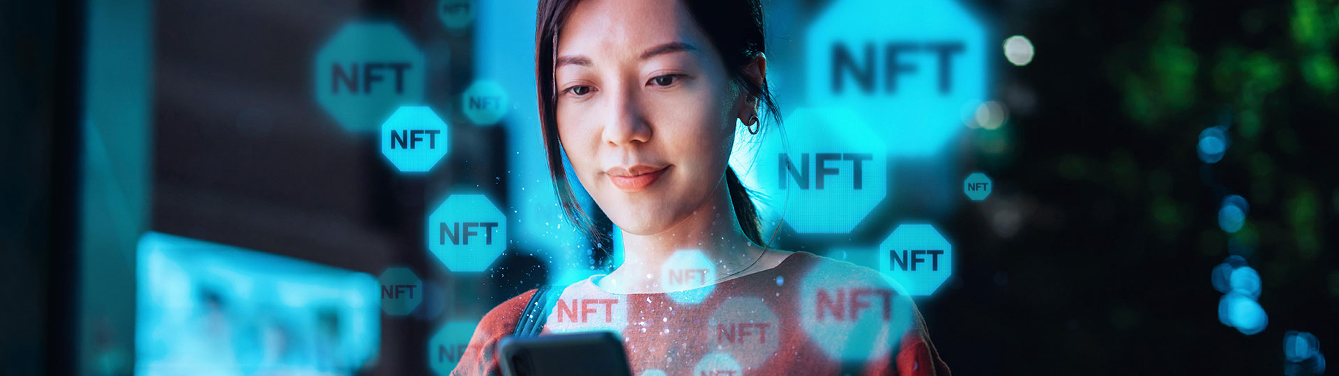 A woman looking at smart phone with an overlay of NFT logos