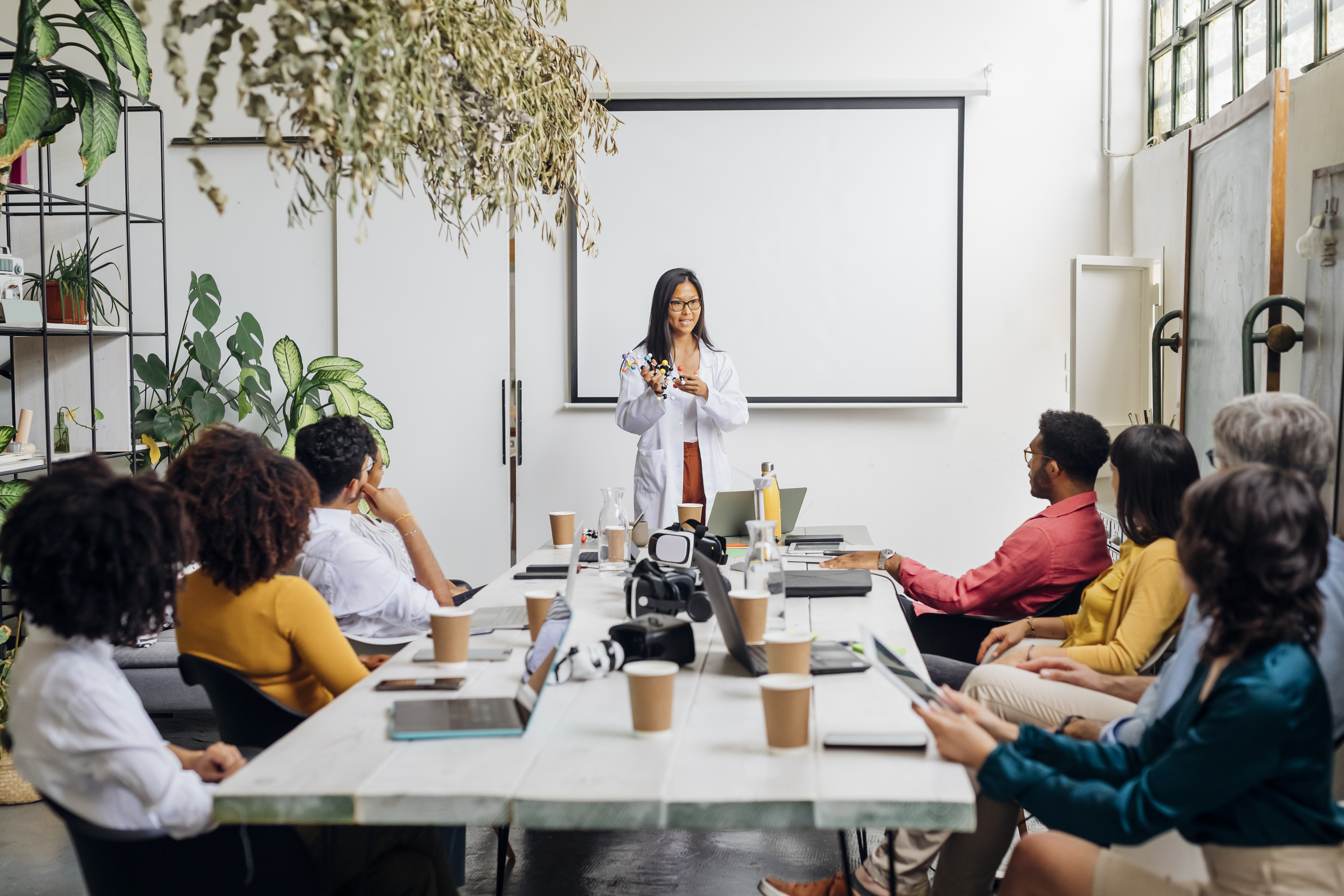 Group of people listening to a presenter in a meeting room