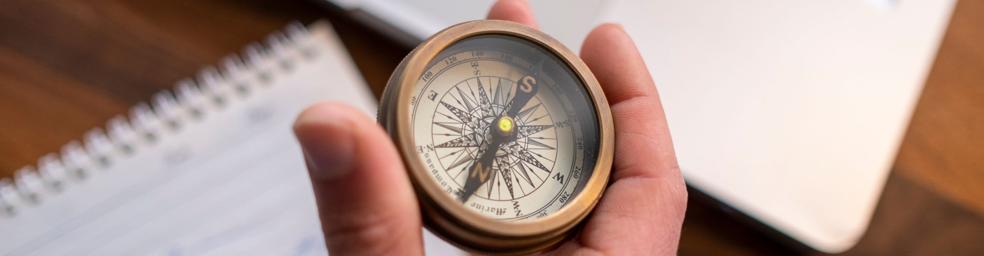 Hand holding a compass