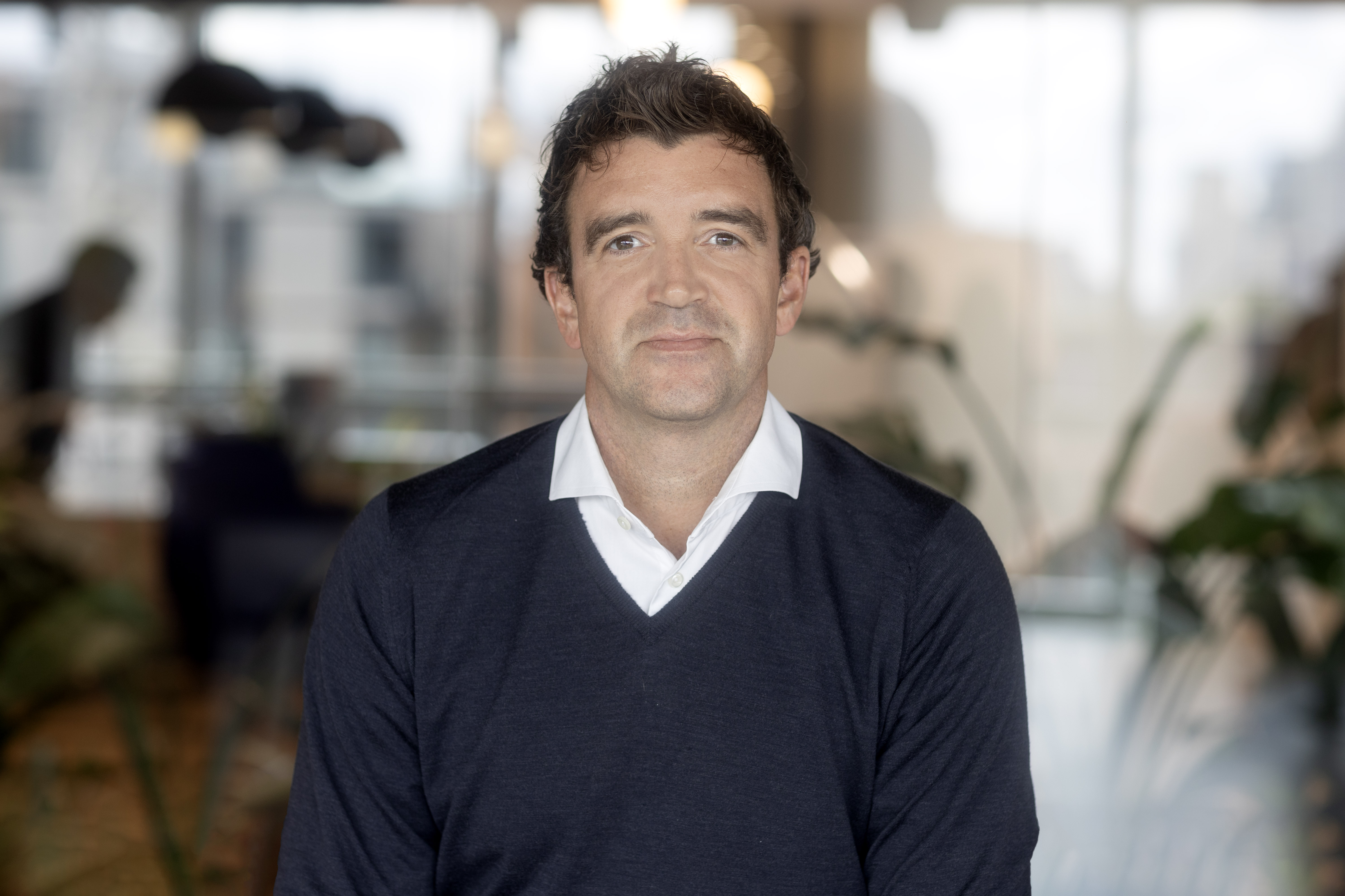 A professional headshot of Joe Abbott