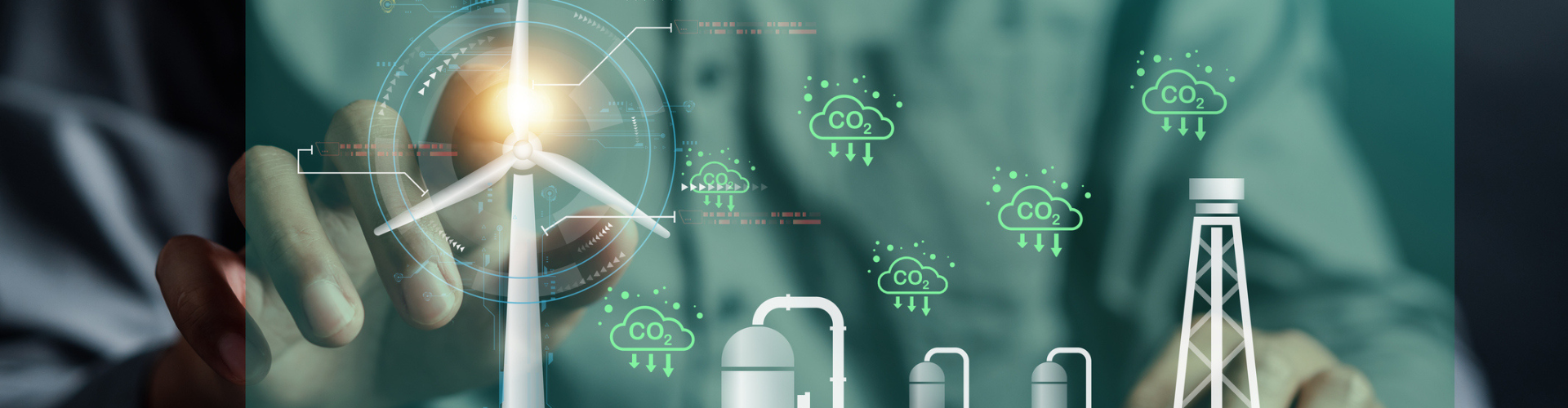 Hand touching a model of a wind turbine