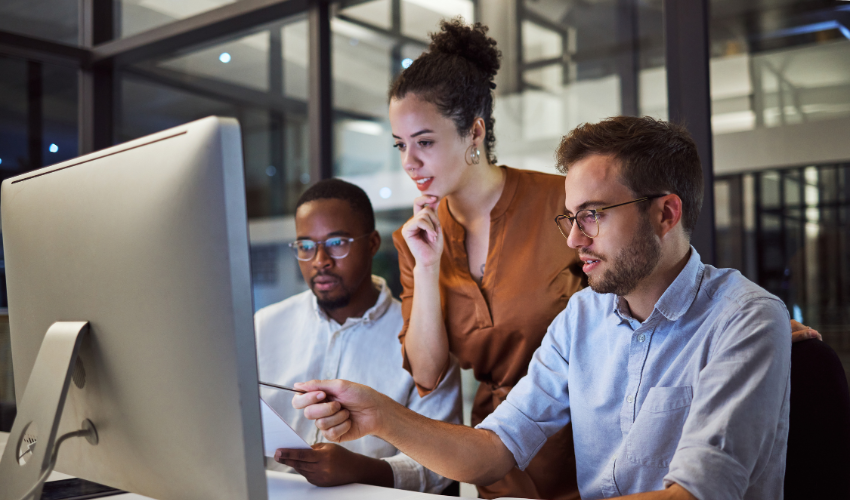 People in an office looking at a screen