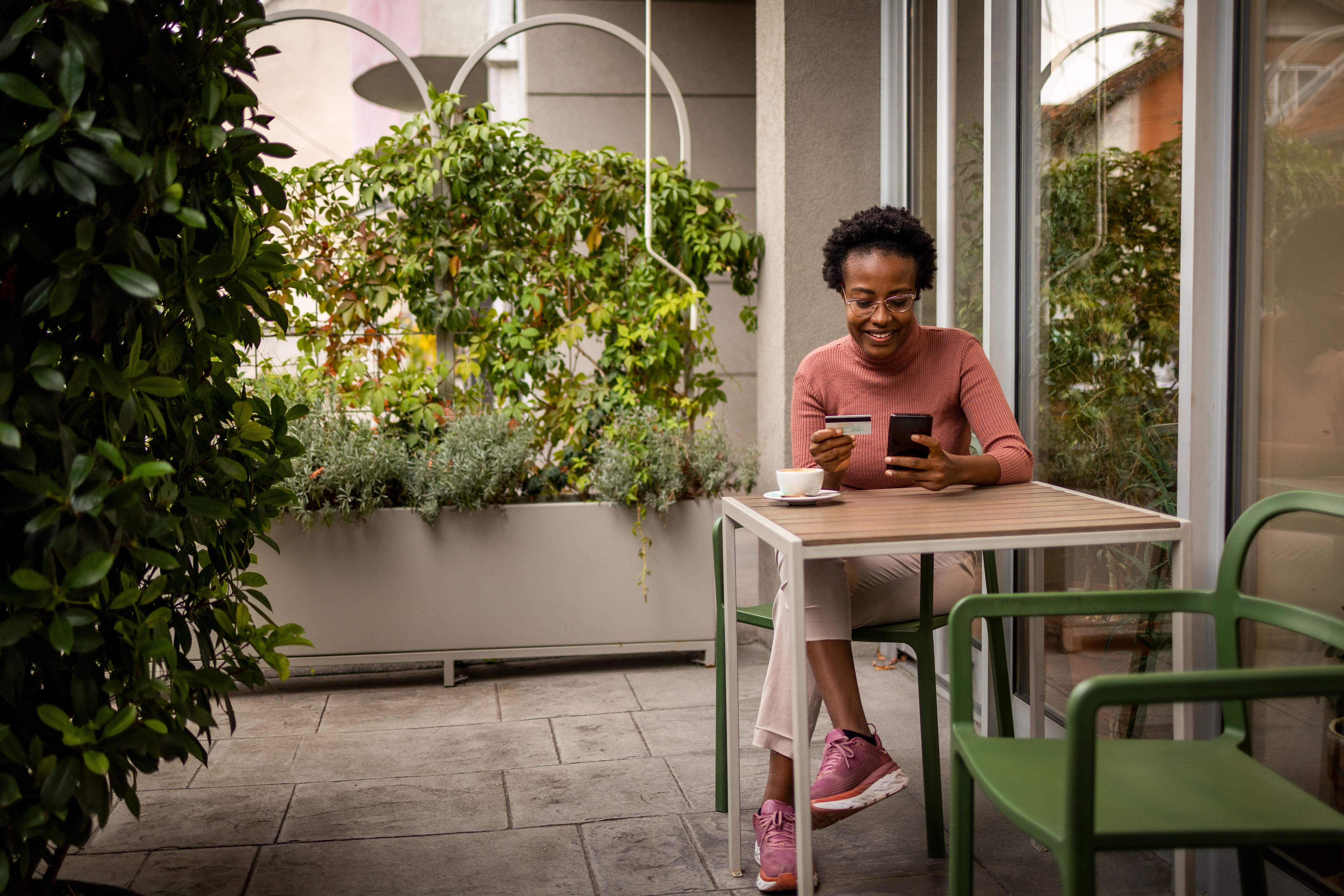 Woman pays for coffee on her phone