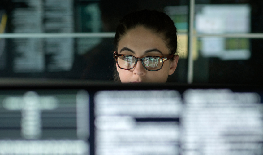 Woman working behind a screen in an office