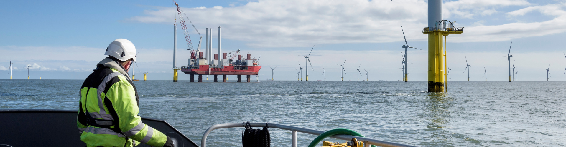 Man on a boat looking at an offshore facility