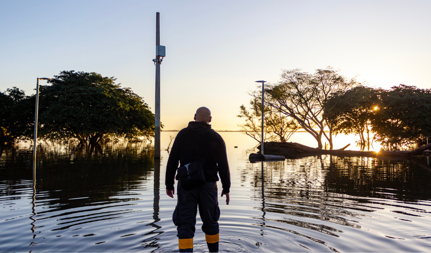 Man looking at a flooded landscape