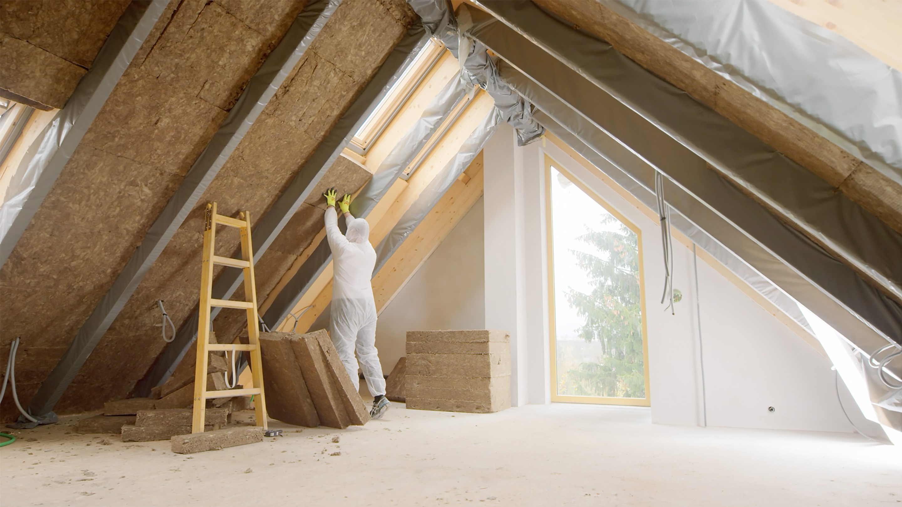 Worker retrofitting a house