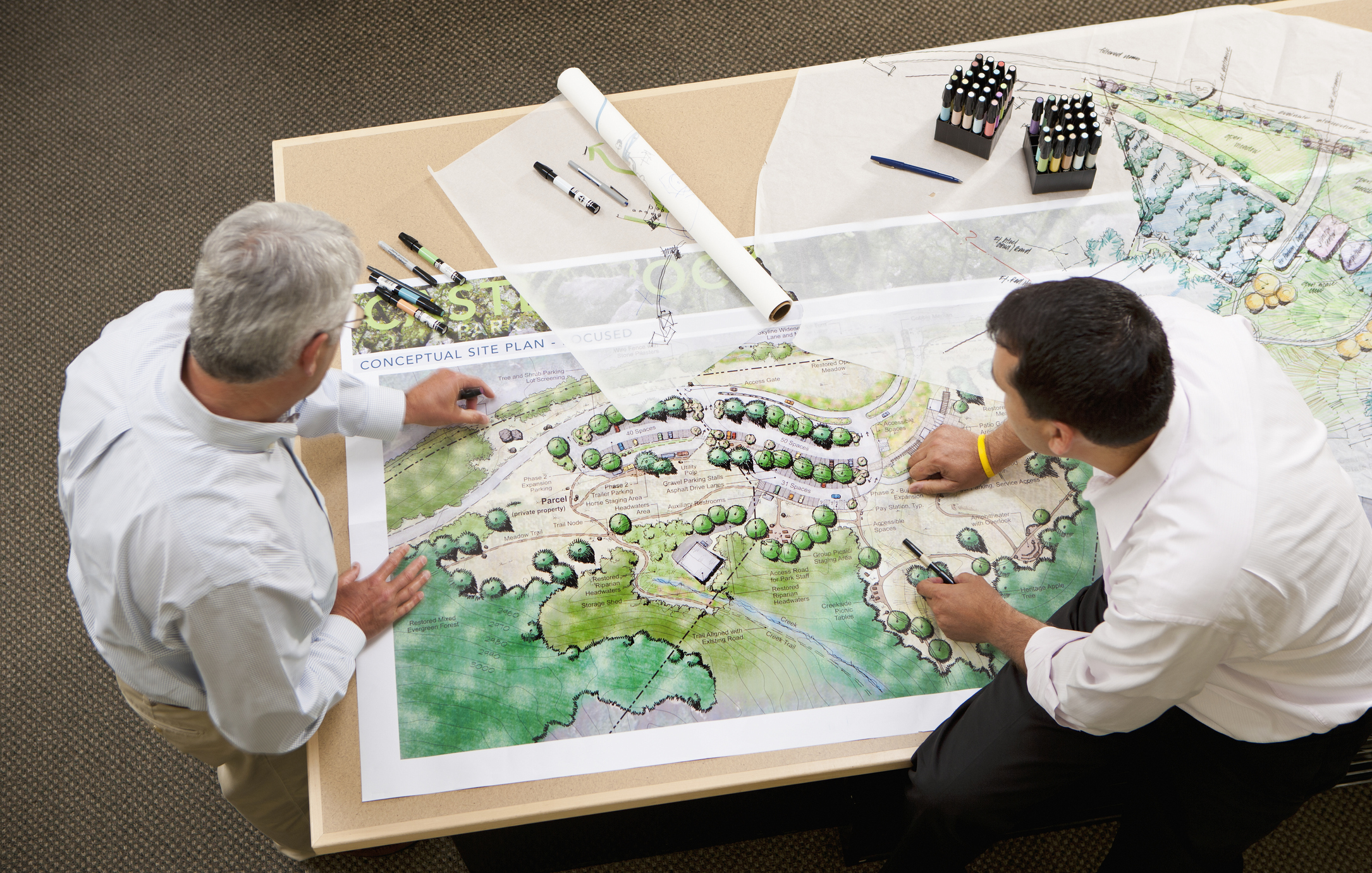 Two men looking at land plans