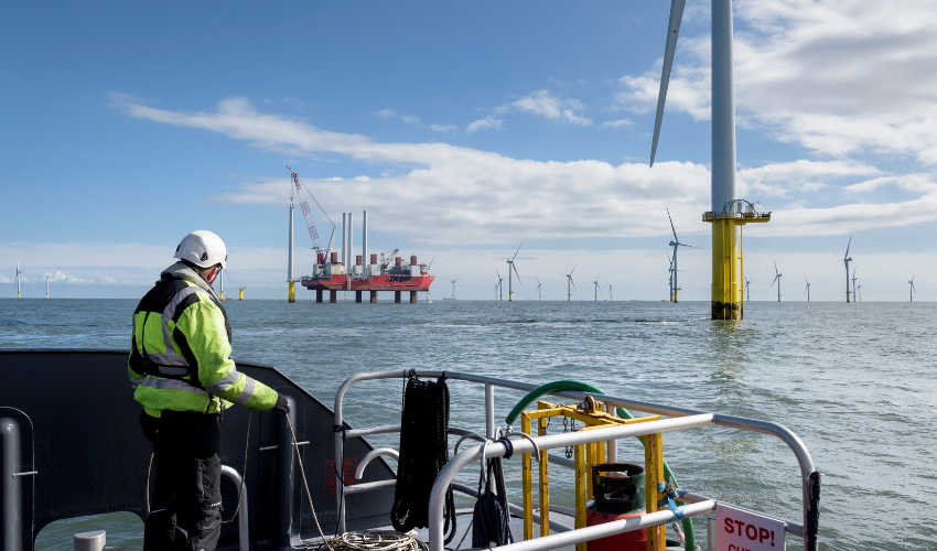 Man on a boat looking at an offshore facility