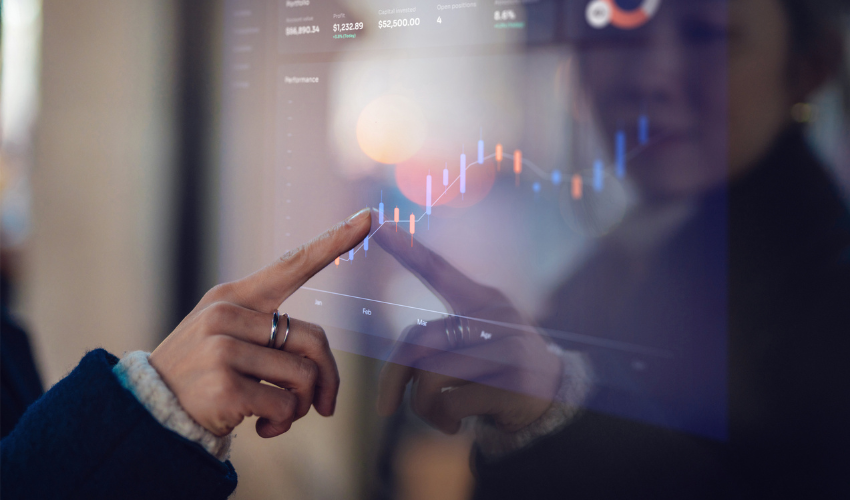 Finger touching a screen that is displaying a graph