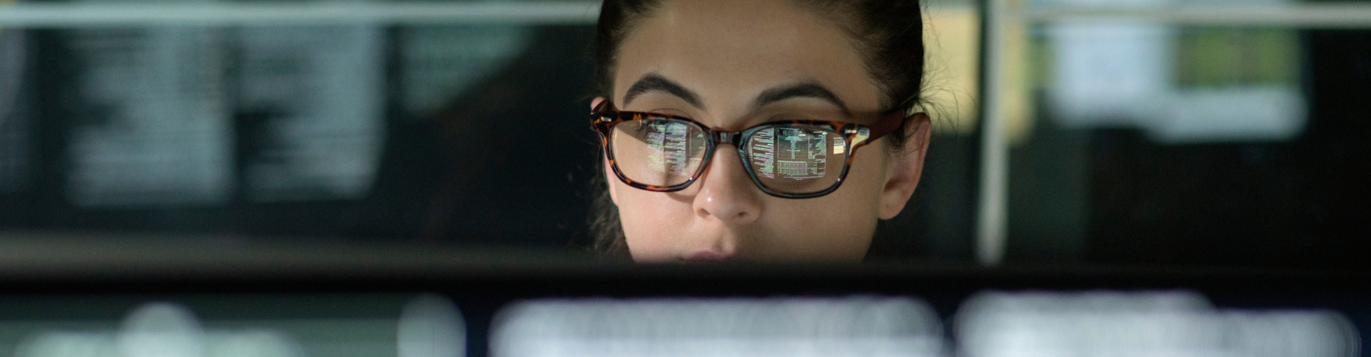 Woman working behind a screen in an office