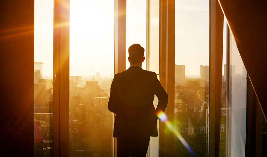 Man looking out of office window