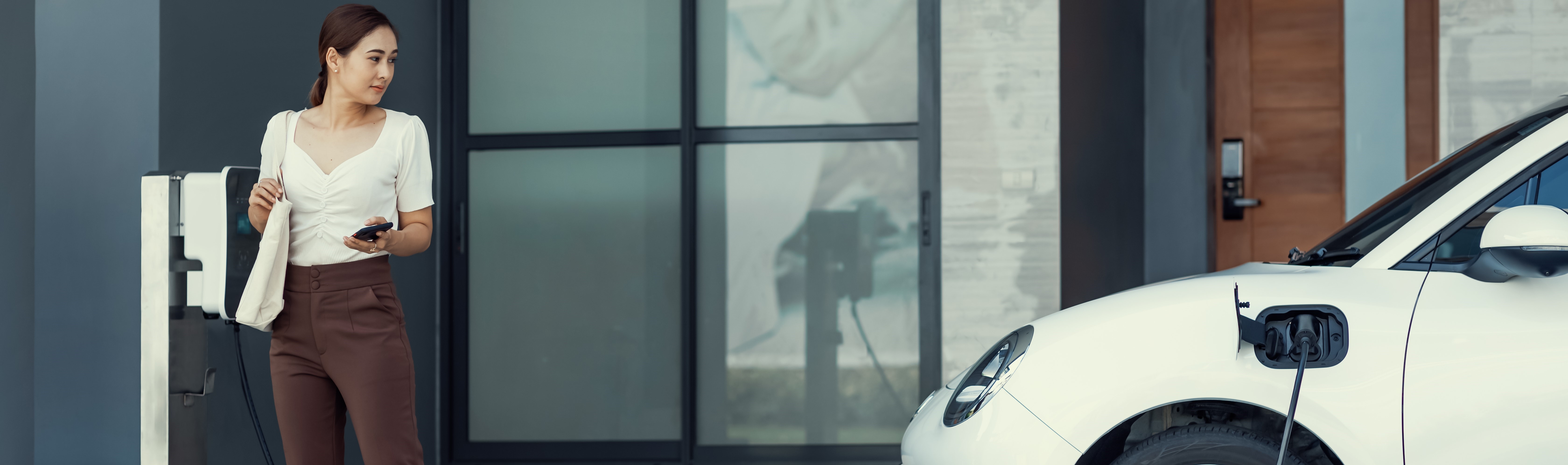 Woman charging an electric car