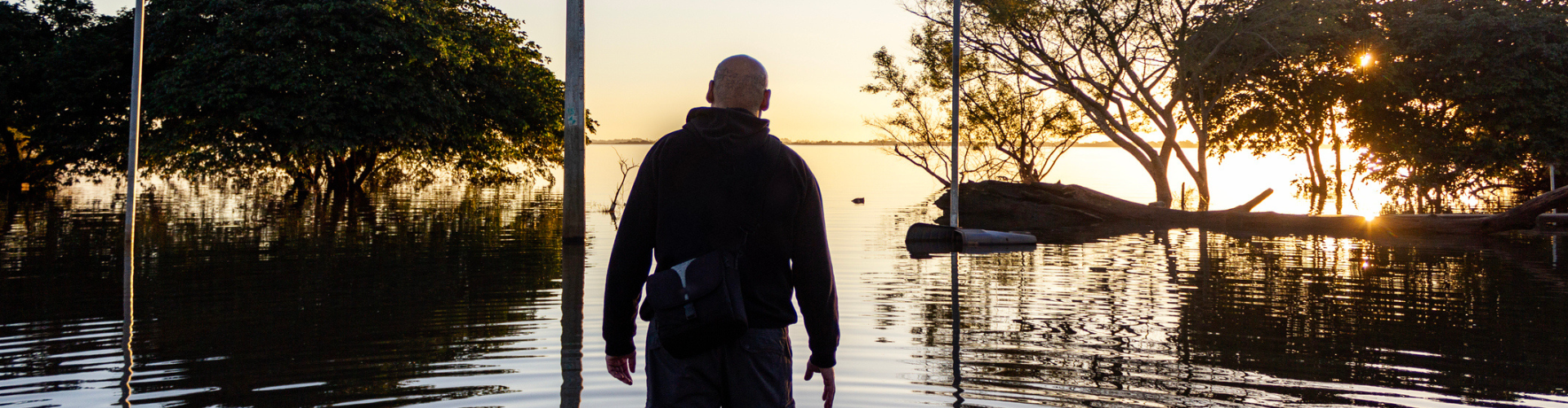 Man looking at a flooded landscape