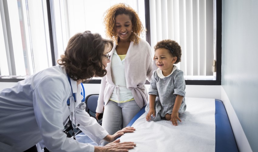 doctor attending to parent and child