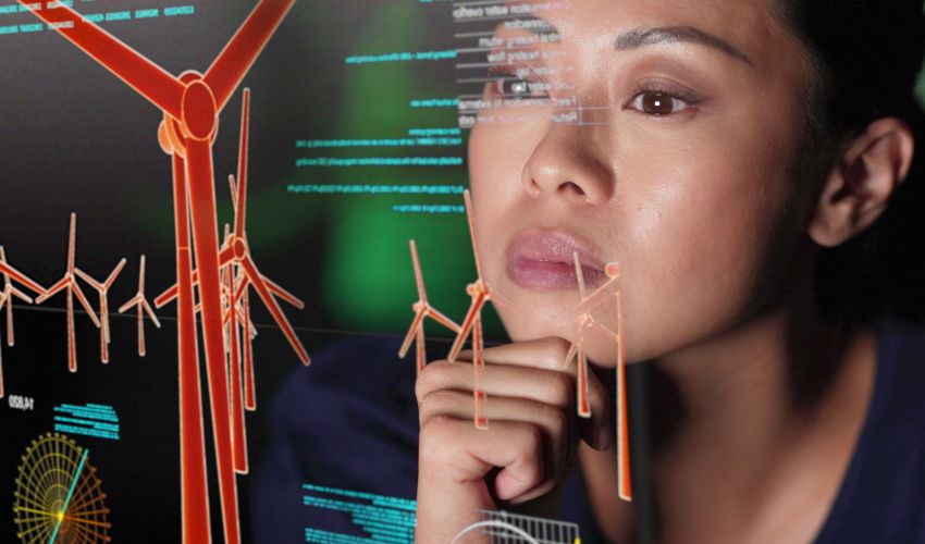 Woman looking at a screen showing data and models of wind turbines
