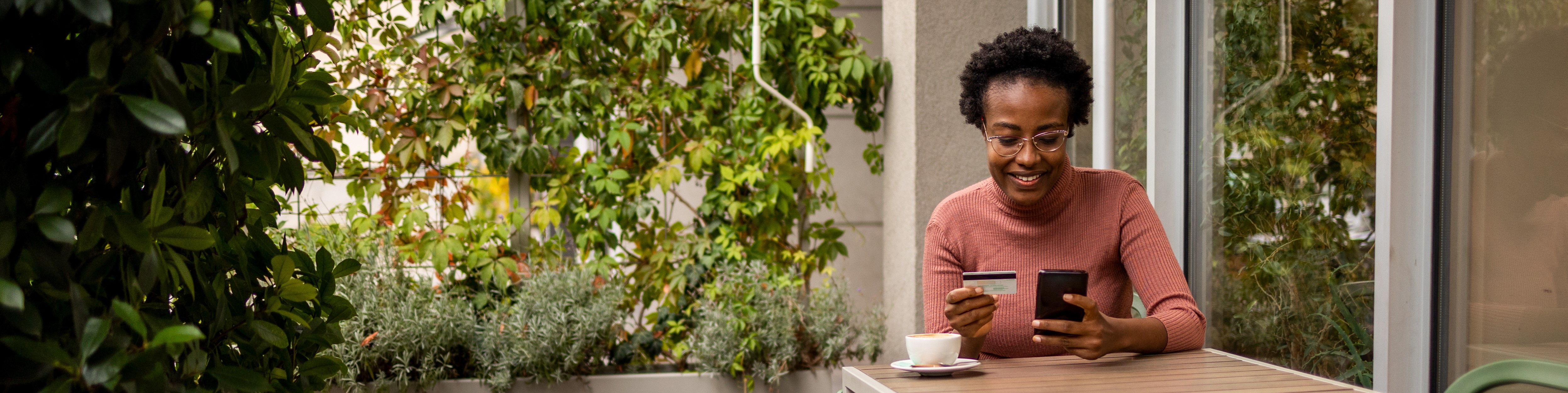 Woman paying for coffee on her phone