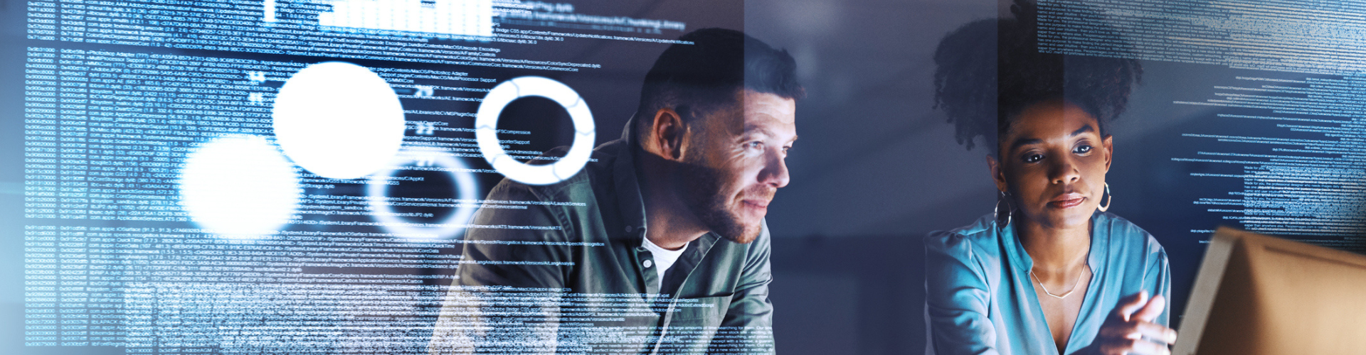Two colleagues looking a data on a screen