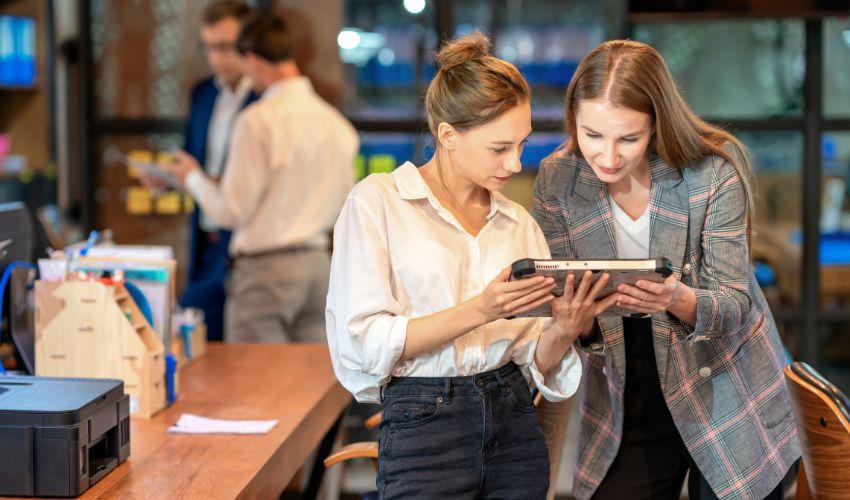 Two female colleagues looking at a tablet