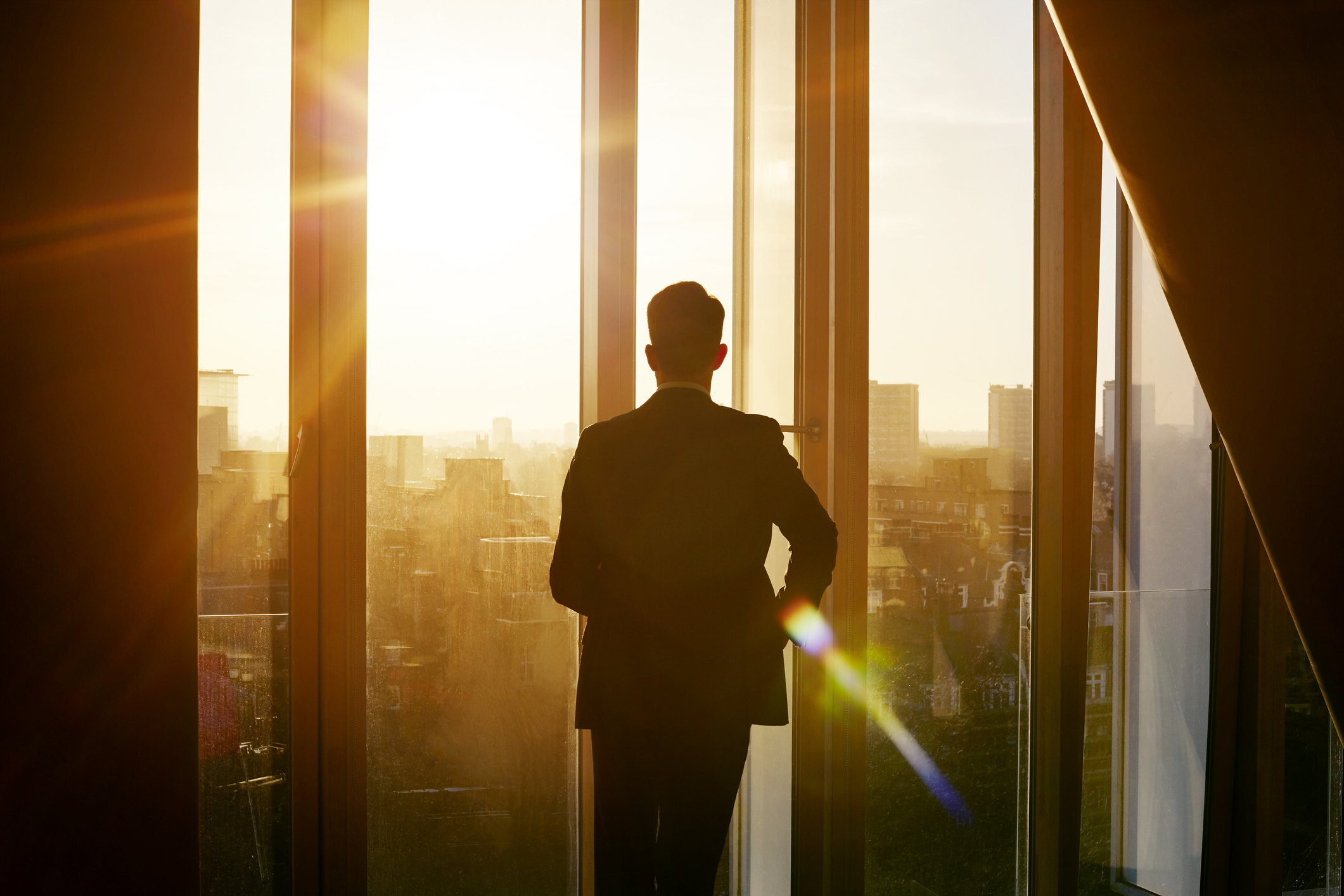 Man looking out of office window