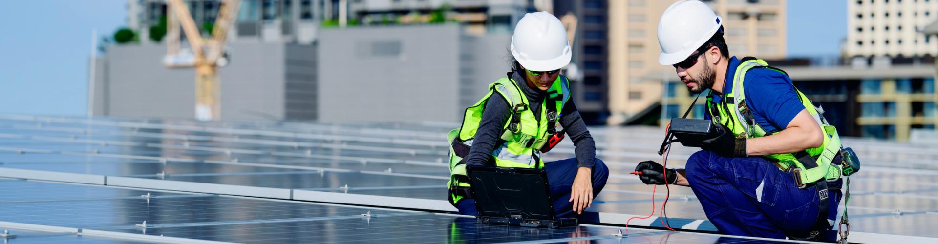 Workers inspecting a solar panel